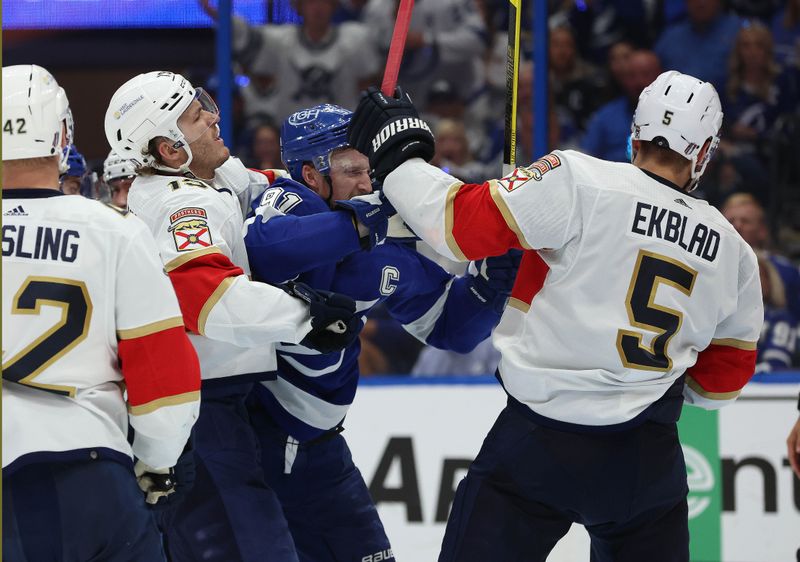 Apr 27, 2024; Tampa, Florida, USA; Tampa Bay Lightning center Steven Stamkos (91), Florida Panthers defenseman Aaron Ekblad (5) and Florida Panthers left wing Matthew Tkachuk (19) defend during the third period in game four of the first round of the 2024 Stanley Cup Playoffs at Amalie Arena. Mandatory Credit: Kim Klement Neitzel-USA TODAY Sports