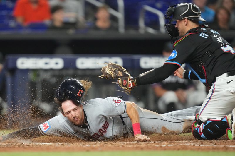 Jun 7, 2024; Miami, Florida, USA;  Cleveland Guardians third base Daniel Schneemann (10) gets tagged out at home plate by Miami Marlins catcher Nick Fortes (4) in the eighth inning at loanDepot Park. Mandatory Credit: Jim Rassol-USA TODAY Sports