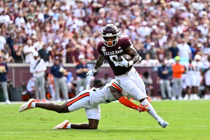 Sep 23, 2023; College Station, Texas, USA; Auburn Tigers cornerback Jaylin Simpson (36) tackles Texas A&M Aggies wide receiver Ainias Smith (0) during the first quarter at Kyle Field. Mandatory Credit: Maria Lysaker-USA TODAY Sports