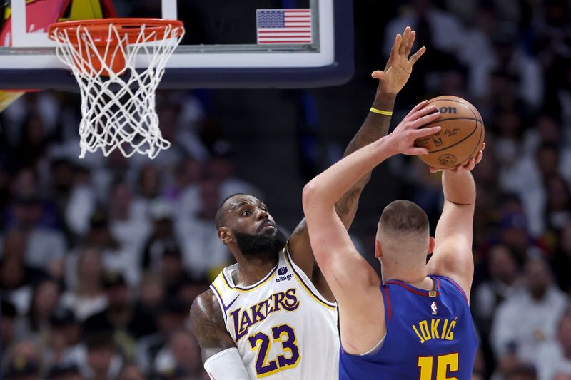 DENVER, COLORADO - APRIL 20: LeBron James #23 of the Los Angeles Lakers guards Nikola Jokic #15 of the Denver Nuggets in the first quarter during game one of the Western Conference First Round Playoffs at Ball Arena on April 20, 2024 in Denver, Colorado.  NOTE TO USER: User expressly acknowledges and agrees that, by downloading and or using this photograph, User is consenting to the terms and conditions of the Getty Images License Agreement. (Photo by Matthew Stockman/Getty Images)