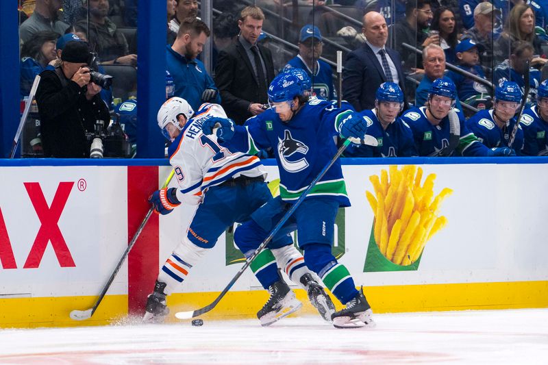 Oct 4, 2024; Vancouver, British Columbia, CAN; Vancouver Canucks forward Kiefer Sherwood (44) checks Edmonton Oilers forward Mattias Janmark (13) during the third period at Rogers Arena. Mandatory Credit: Bob Frid-Imagn Images