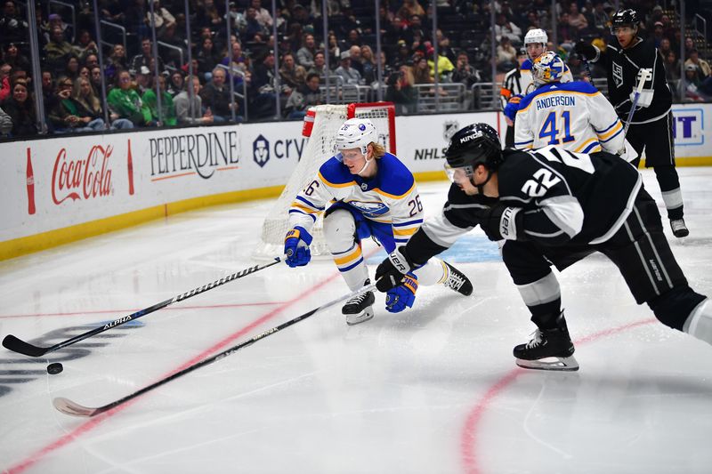 Feb 13, 2023; Los Angeles, California, USA; Buffalo Sabres defenseman Rasmus Dahlin (26) plays for the puck against Los Angeles Kings left wing Kevin Fiala (22) during the second period at Crypto.com Arena. Mandatory Credit: Gary A. Vasquez-USA TODAY Sports