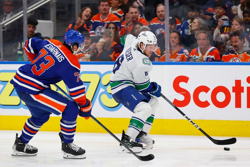 May 12, 2024; Edmonton, Alberta, CAN; Vancouver Canucks forward Brock Boeser (6) carries the puck around Edmonton Oilers defensemen Vincent Desharnais (73) during the second period in game three of the second round of the 2024 Stanley Cup Playoffs at Rogers Place. Mandatory Credit: Perry Nelson-USA TODAY Sports