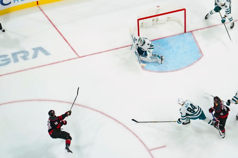 Oct 27, 2023; Raleigh, North Carolina, USA; Carolina Hurricanes left wing Michael Bunting (58) takes a shot at San Jose Sharks goaltender Kaapo Kahkonen (36) during the third period at PNC Arena. Mandatory Credit: James Guillory-USA TODAY Sports