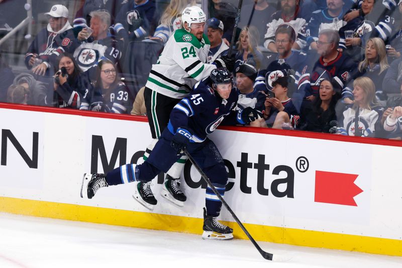 Oct 9, 2025; Winnipeg, Manitoba, CAN; Winnipeg Jets left wing Cole Koepke (45) is checked by Dallas Stars center Roope Hintz (24) during the third period at Canada Life Centre. Mandatory Credit: James Carey Lauder-Imagn Images