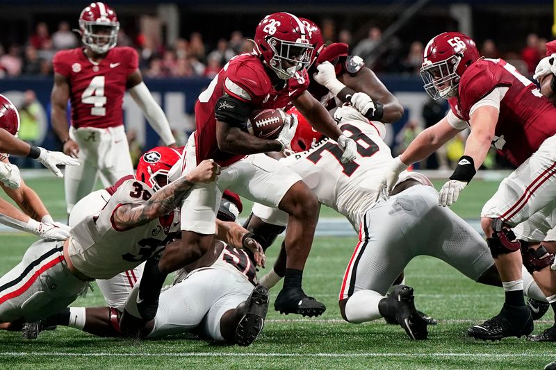 Dec 2, 2023; Atlanta, GA, USA; Alabama Crimson Tide running back Jam Miller (26) rushes the ball against the Georgia Bulldogs during the first half in the SEC Championship game at Mercedes-Benz Stadium. Mandatory Credit: Dale Zanine-USA TODAY Sports