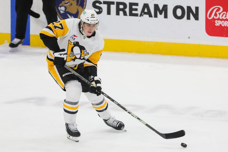 Dec 8, 2023; Sunrise, Florida, USA; Pittsburgh Penguins defenseman Ryan Graves (27) moves the puck against the Florida Panthers during the third period at Amerant Bank Arena. Mandatory Credit: Sam Navarro-USA TODAY Sports