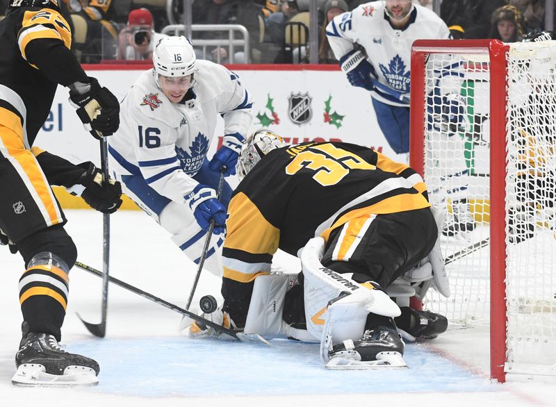 Nov 25, 2023; Pittsburgh, Pennsylvania, USA; Pittsburgh Penguins goalie Tristan Jarry (35) stops Toronto Maple Leafs right wing Mitchell Marner (16) during the second period at PPG Paints Arena. Mandatory Credit: Philip G. Pavely-USA TODAY Sports