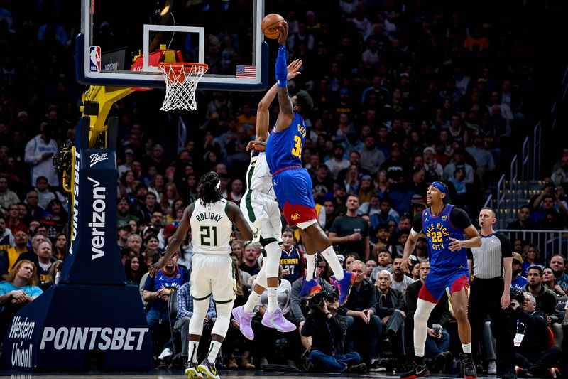 DENVER, CO - MARCH 25:  Jeff Green #32 of the Denver Nuggets jumps to slam the ball over a block attempot by Giannis Antetokounmpo #34 of the Milwaukee Bucks in the second half of a game at Ball Arena on March 25, 2023 in Denver, Colorado. NOTE TO USER: User expressly acknowledges and agrees that, by downloading and or using this photograph, User is consenting to the terms and conditions of the Getty Images License Agreement. (Photo by Dustin Bradford/Getty Images)