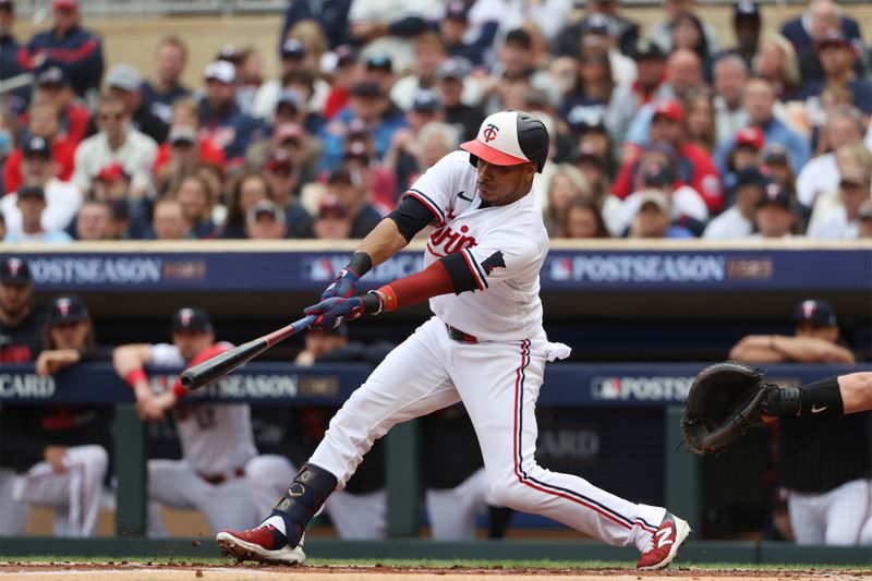 Oct 4, 2023; Minneapolis, Minnesota, USA; Minnesota Twins second baseman Jorge Polanco (11) hits a single a single in the in the first inning against the Toronto Blue Jays  during game two of the Wildcard series for the 2023 MLB playoffs at Target Field. Mandatory Credit: Jesse Johnson-USA TODAY Sports