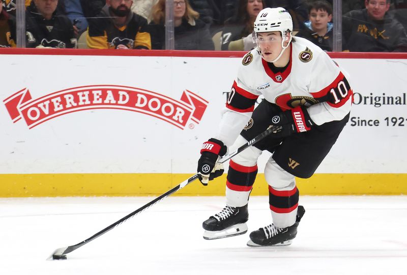 Feb 2, 2026; Pittsburgh, Pennsylvania, USA;  Ottawa Senators defenseman Jordan Spence (10) handles the puck against the Pittsburgh Penguins during the third period at PPG Paints Arena. Mandatory Credit: Charles LeClaire-Imagn Images