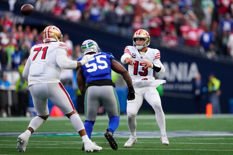 San Francisco 49ers quarterback Brock Purdy (13) throws during the first half of an NFL football game against the Seattle Seahawks, Thursday, Oct. 10, 2024, in Seattle. (AP Photo/Lindsey Wasson)