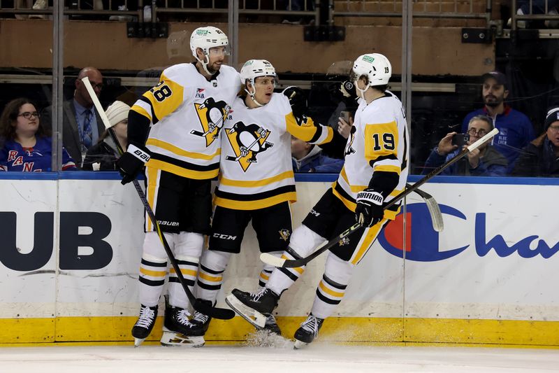 Dec 6, 2024; New York, New York, USA; Pittsburgh Penguins center Blake Lizotte (46) celebrates his goal against the New York Rangers with defenseman Marcus Pettersson (28) and center Cody Glass (19) during the second period at Madison Square Garden. Mandatory Credit: Brad Penner-Imagn Images