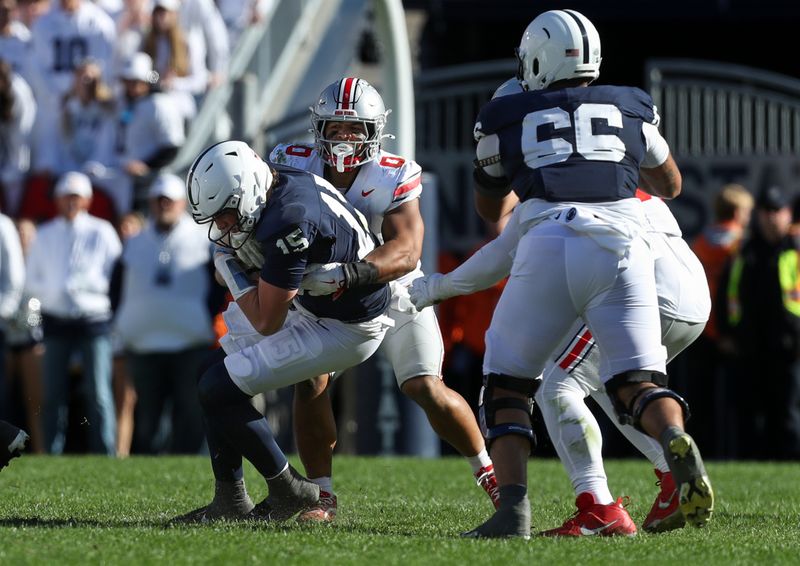 Nov 2, 2024; University Park, Pennsylvania, USA; Ohio State Buckeyes linebacker Cody Simon (0) sacks Penn State Nittany Lions quarterback Drew Allar (15) during the third quarter at Beaver Stadium. Mandatory Credit: Matthew O'Haren-Imagn Images
