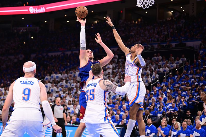 OKLAHOMA CITY, OKLAHOMA - MAY 13: Nikola Jokic #15 of the Denver Nuggets shoots against Aaron Wiggins #21 and Isaiah Hartenstein #55 of the Oklahoma City Thunder during the second half of game five of the Western Conference semifinals at Paycom Center on May 13, 2025 in Oklahoma City, Oklahoma. NOTE TO USER: User expressly acknowledges and agrees that, by downloading and or using this photograph, User is consenting to the terms and conditions of the Getty Images License Agreement. (Photo by Joshua Gateley/Getty Images)