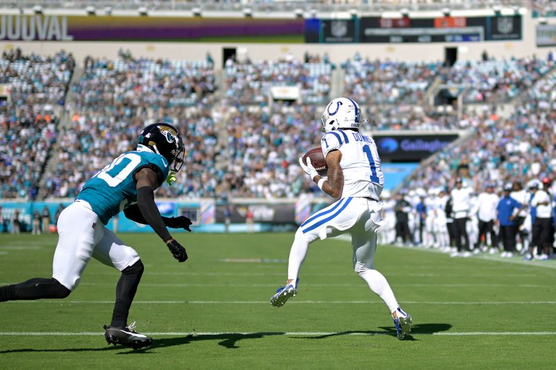 Indianapolis Colts wide receiver Josh Downs (1) catches a pass in the end zone in front of Jacksonville Jaguars cornerback Montaric Brown (30) for a touchdown during the second half of an NFL football game, Sunday, Oct. 15, 2023, in Jacksonville, Fla. (AP Photo/Phelan M. Ebenhack)