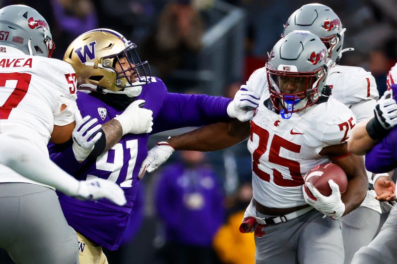 Nov 25, 2023; Seattle, Washington, USA; Washington Huskies defensive lineman Tuli Letuligasenoa (91) tackles Washington State Cougars running back Nakia Watson (25) during the fourth quarter at Alaska Airlines Field at Husky Stadium. Mandatory Credit: Joe Nicholson-USA TODAY Sports