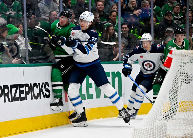 Feb 29, 2024; Dallas, Texas, USA; Winnipeg Jets center Morgan Barron (36) checks Dallas Stars defenseman Ryan Suter (20) during the first period at the American Airlines Center. Mandatory Credit: Jerome Miron-USA TODAY Sports