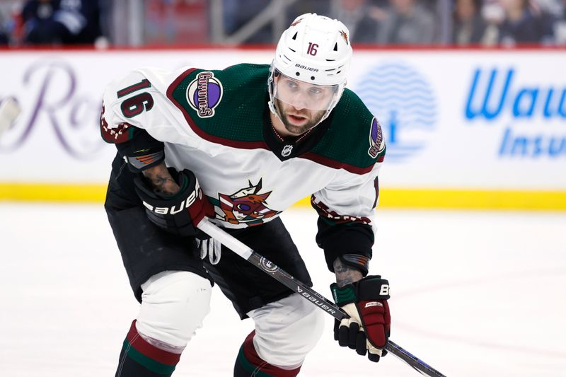 Feb 25, 2024; Winnipeg, Manitoba, CAN; Arizona Coyotes left wing Jason Zucker (16) looks on before a face off in the first period against the Winnipeg Jets at Canada Life Centre. Mandatory Credit: James Carey Lauder-USA TODAY Sports