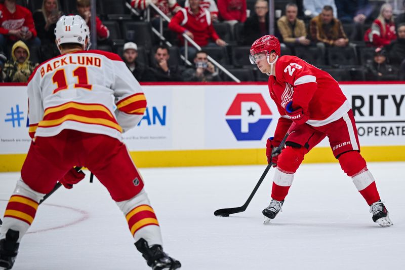 Nov 27, 2024; Detroit, Michigan, USA; Detroit Red Wings left wing Lucas Raymond (23) scores the game winning goal in overtime against the Calgary Flames at Little Caesars Arena. Mandatory Credit: Tim Fuller-Imagn Images