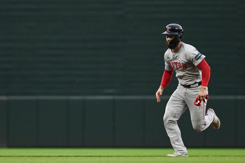 May 29, 2024; Baltimore, Maryland, USA;  Boston Red Sox catcher Connor Wong (12) advances to third base on a throwing error in the second inning against the Baltimore Orioles at Oriole Park at Camden Yards. Mandatory Credit: Tommy Gilligan-USA TODAY Sports