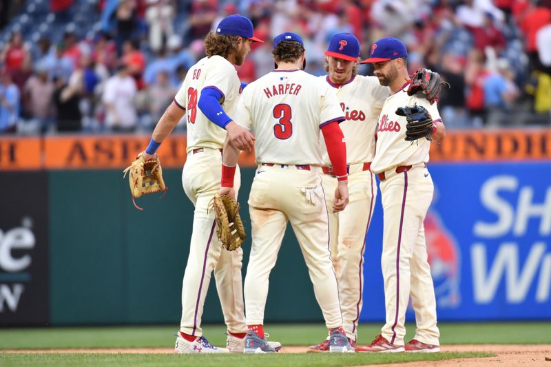 May 6, 2024; Philadelphia, Pennsylvania, USA;  Philadelphia Phillies third base Alec Bohm (28), first base Bryce Harper (3), second base Bryson Stott (5) and outfielder Whit Merrifield (9) celebrate win against the San Francisco Giants at Citizens Bank Park. Mandatory Credit: Eric Hartline-USA TODAY Sports