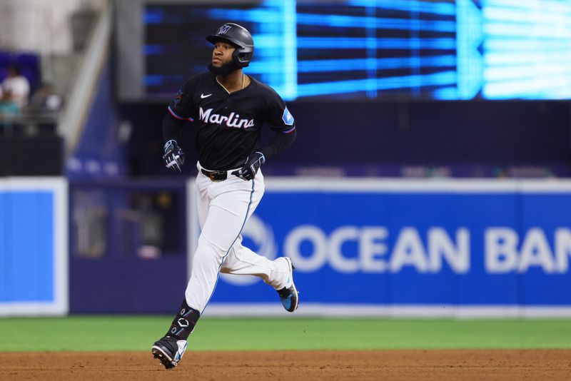 Jun 21, 2024; Miami, Florida, USA; Miami Marlins left fielder Bryan De La Cruz (14) circles the bases after hitting a home run against the Seattle Mariners during the sixth inning at loanDepot Park. Mandatory Credit: Sam Navarro-USA TODAY Sports