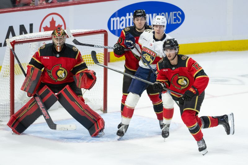 Jan 10, 2026; Ottawa, Ontario, CAN; Ottawa Senators center Shane Pinto (12) and defenseman Jordan Spence (10) defend against Florida Panthers left wing Sandis Vilmanis (95) as he jockeys for position in from of Senators goalie Leevi Merilainen (1) in the third period at the Canadian Tire Centre. Mandatory Credit: Marc DesRosiers-IMAGN Images