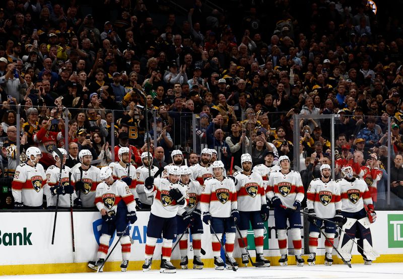 Oct 21, 2025; Boston, Massachusetts, USA; As his teammates look on, Florida Panthers left wing Brad Marchand (63) raises his stick to acknowledge the applause from Boston fans after a tribute to him played during a timeout in the first period against the Boston Bruins at TD Garden. Mandatory Credit: Winslow Townson-Imagn Images