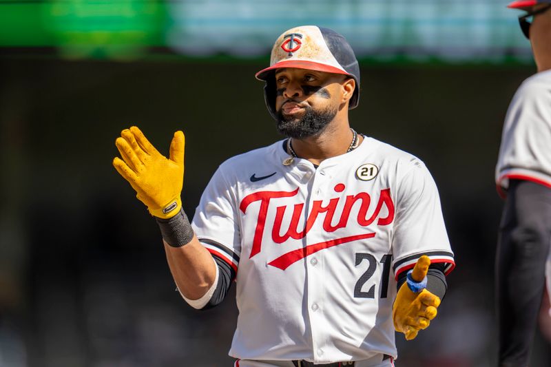 Sep 15, 2024; Minneapolis, Minnesota, USA; Minnesota Twins first baseman Carlos Santana (21) celebrates after hitting a single against the Cincinnati Reds in the fourth inning at Target Field. Mandatory Credit: Jesse Johnson-Imagn Images