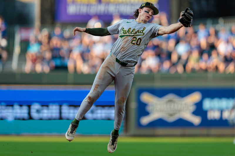 May 18, 2024; Kansas City, Missouri, USA; Oakland Athletics second base Zack Gelof (20) makes a leaping catch during the fifth inning against the Kansas City Royals at Kauffman Stadium. Mandatory Credit: William Purnell-USA TODAY Sports