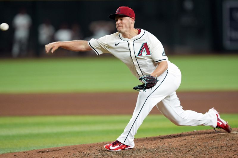 Jun 13, 2024; Phoenix, Arizona, USA; Arizona Diamondbacks pitcher Paul Sewald (38) pitches against the Los Angeles Angels during the ninth inning at Chase Field. Mandatory Credit: Joe Camporeale-USA TODAY Sports