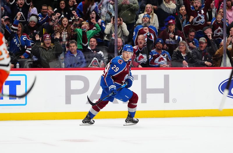 Oct 18, 2024; Denver, Colorado, USA; Colorado Avalanche center Nathan MacKinnon (29) celebrates his overtime goal against the Anaheim Ducks at Ball Arena. Mandatory Credit: Ron Chenoy-Imagn Images