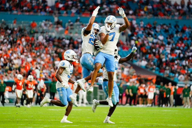 Oct 8, 2022; Miami Gardens, Florida, USA; North Carolina Tar Heels celebrates a fumble interception against the Miami Hurricanes during the second half at Hard Rock Stadium. Mandatory Credit: Rich Storry-USA TODAY Sports