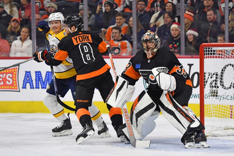 Dec 21, 2023; Philadelphia, Pennsylvania, USA; Nashville Predators center Gustav Nyquist (14) is defended by Philadelphia Flyers defenseman Cam York (8) in front of goaltender Samuel Ersson (33) during the first period at Wells Fargo Center. Mandatory Credit: Eric Hartline-USA TODAY Sports