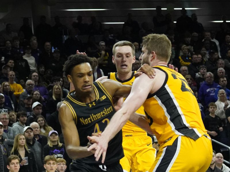 Mar 2, 2024; Evanston, Illinois, USA; Iowa Hawkeyes forward Ben Krikke (23) defends Northwestern Wildcats guard Blake Smith (43) during the second half at Welsh-Ryan Arena. Mandatory Credit: David Banks-USA TODAY Sports