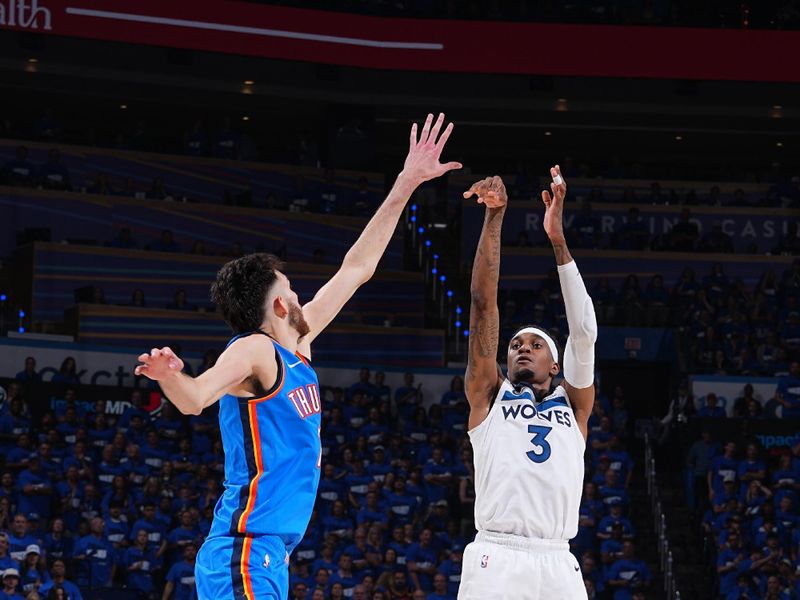 OKLAHOMA CITY, OK - MAY 22:   Jaden McDaniels #3 of the Minnesota Timberwolves shoots a three point basket during the game against the Oklahoma City Thunder  during Game 2 of the Western Conference Finals  on May 22, 2025 at Paycom Center in Oklahoma City, Oklahoma. NOTE TO USER: User expressly acknowledges and agrees that, by downloading and or using this photograph, User is consenting to the terms and conditions of the Getty Images License Agreement. Mandatory Copyright Notice: Copyright 2025 NBAE (Photo by Garrett Ellwood/NBAE via Getty Images)