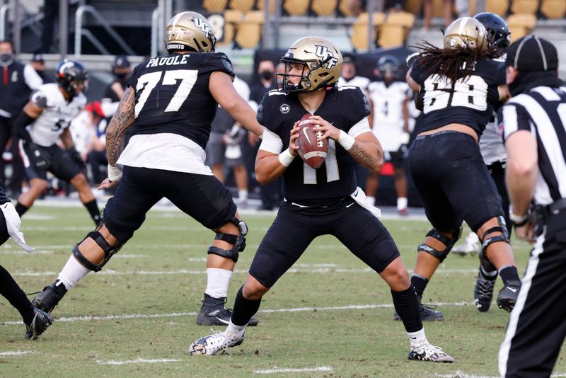 Nov 21, 2020; Orlando, Florida, USA; UCF Knights quarterback Dillon Gabriel (11) drops to throw a pass during the first quarter against the Cincinnati Bearcats at the Bounce House. Mandatory Credit: Reinhold Matay-USA TODAY Sports