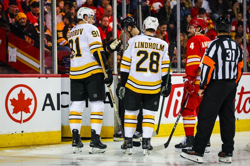 Dec 29, 2025; Calgary, Alberta, CAN; Problem with the boards prior to the second period between the Calgary Flames and the Boston Bruins at Scotiabank Saddledome. Mandatory Credit: Sergei Belski-Imagn Images