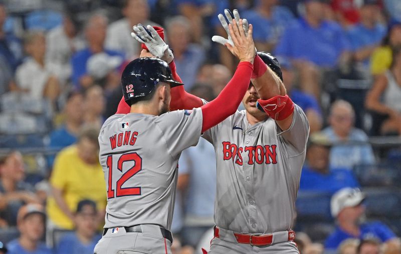 Aug 5, 2024; Kansas City, Missouri, USA;  Boston Red Sox pinch hitter Romy Gonzalez (23) celebrates with Connor Wong (12) after hitting a two run home run in the seventh inning against the Kansas City Royals at Kauffman Stadium. Mandatory Credit: Peter Aiken-USA TODAY Sports