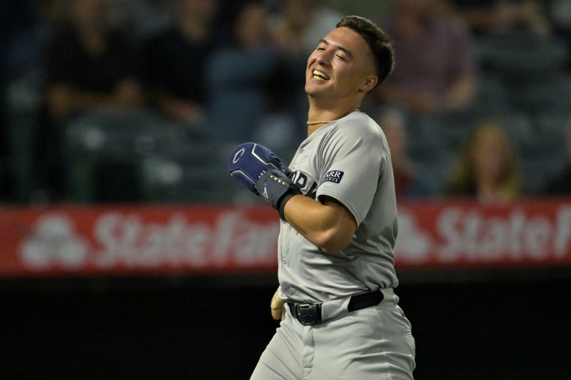 May 30, 2024; Anaheim, California, USA;  New York Yankees shortstop Anthony Volpe (11) smiles as he scores on a triple by right fielder Juan Soto (22) in the seventh inning against the Los Angeles Angels at Angel Stadium. Mandatory Credit: Jayne Kamin-Oncea-USA TODAY Sports