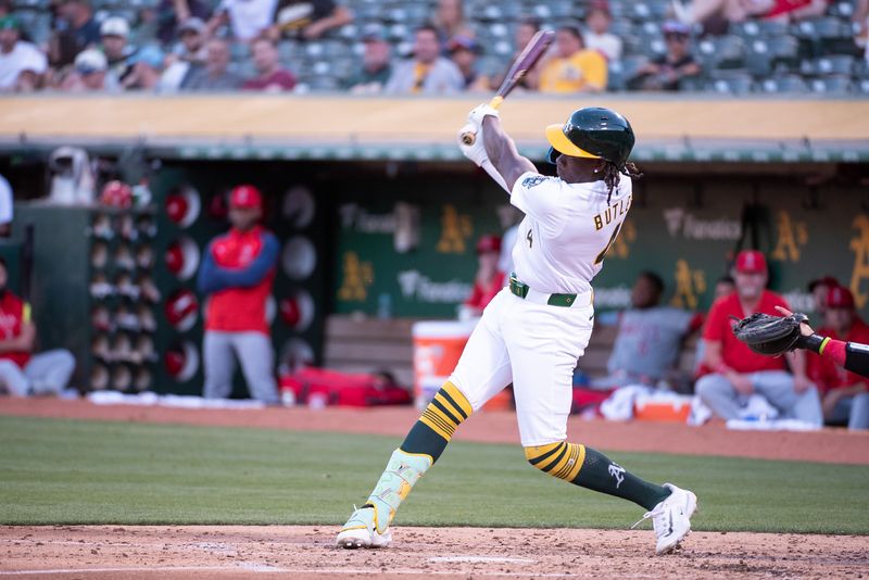 Jul 2, 2024; Oakland, California, USA; Oakland Athletics outfielder Lawrence Butler (4) hits a home run against the Los Angeles Angels during the fourth inning at Oakland-Alameda County Coliseum. Mandatory Credit: Ed Szczepanski-USA TODAY Sports