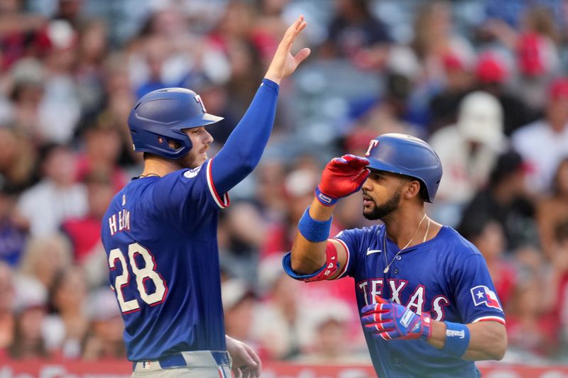 Jul 10, 2024; Anaheim, California, USA; Texas Rangers center fielder Leody Taveras (3) celebrates with catcher Jonah Heim (28) after hitting a two-run home run in the fifth inning against the Los Angeles Angels at Angel Stadium. Mandatory Credit: Kirby Lee-USA TODAY Sports