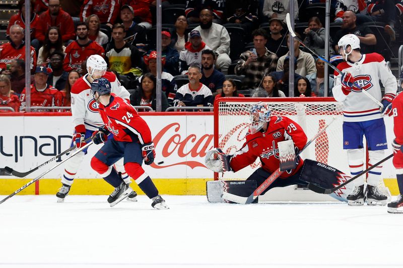 Oct 31, 2024; Washington, District of Columbia, USA; Washington Capitals goaltender Charlie Lindgren (79) makes a save in front of Montreal Canadiens right wing Joel Armia (40) and Capitals center Connor McMichael (24) in the third period at Capital One Arena. Mandatory Credit: Geoff Burke-Imagn Images