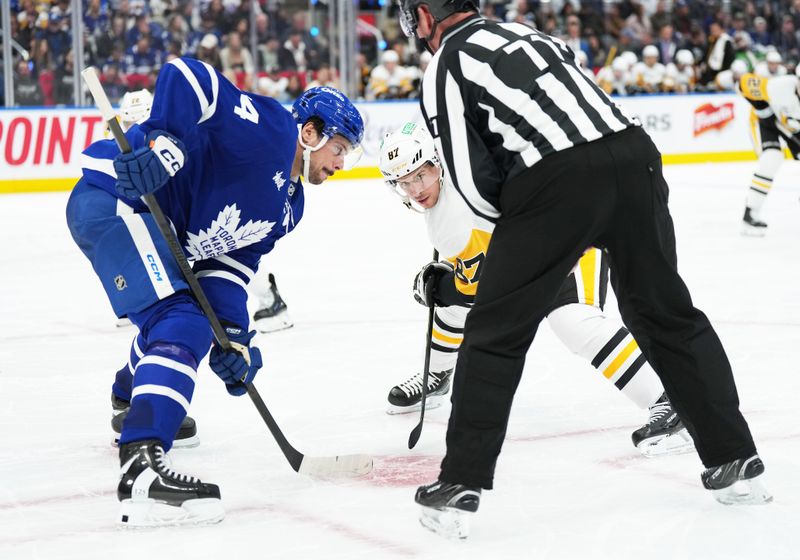 Oct 12, 2024; Toronto, Ontario, CAN; Toronto Maple Leafs center Auston Matthews (34) faces off with Pittsburgh Penguins center Sidney Crosby (87) during the second period at Scotiabank Arena. Mandatory Credit: Nick Turchiaro-Imagn Images