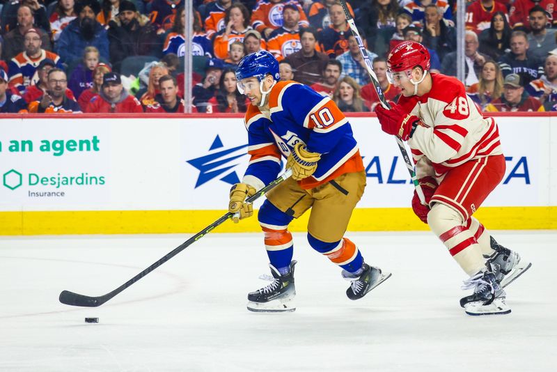 Jan 20, 2024; Calgary, Alberta, CAN; Edmonton Oilers center Derek Ryan (10) controls the puck in front of Calgary Flames defenseman Dennis Gilbert (48) during the first period at Scotiabank Saddledome. Mandatory Credit: Sergei Belski-USA TODAY Sports