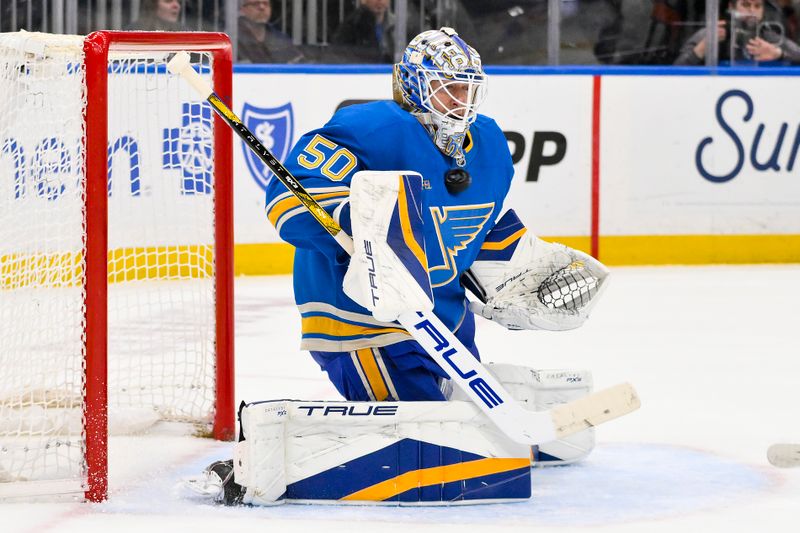 Apr 5, 2025; St. Louis, Missouri, USA;  St. Louis Blues goaltender Jordan Binnington (50) defends the net against the Colorado Avalanche during the first period at Enterprise Center. Mandatory Credit: Jeff Curry-Imagn Images