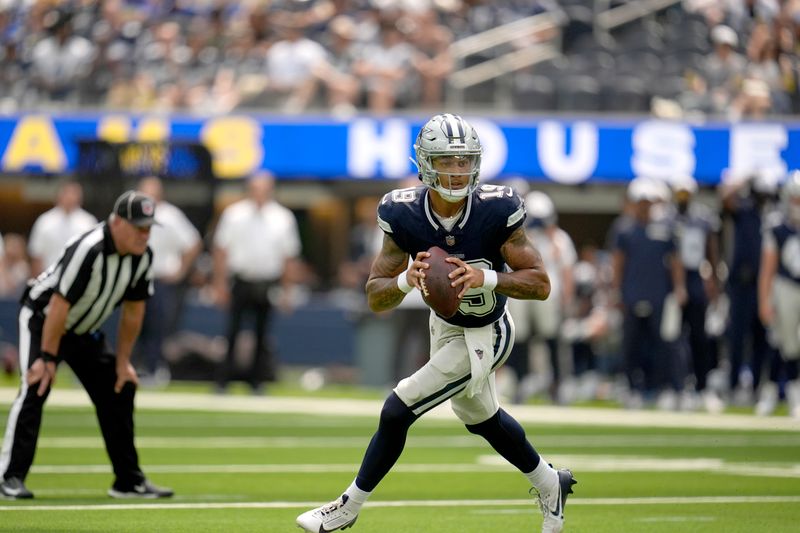 Dallas Cowboys quarterback Trey Lance scrambles out of the pocket during the first half of a preseason NFL football game against the Los Angeles Rams, Sunday, Aug. 11, 2024, in Inglewood, Calif. (AP Photo/Gregory Bull)