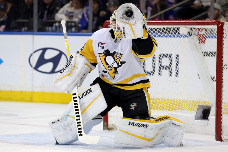 Dec 6, 2024; New York, New York, USA; Pittsburgh Penguins goaltender Alex Nedeljkovic (39) makes a save against the New York Rangers during the first period at Madison Square Garden. Mandatory Credit: Brad Penner-Imagn Images