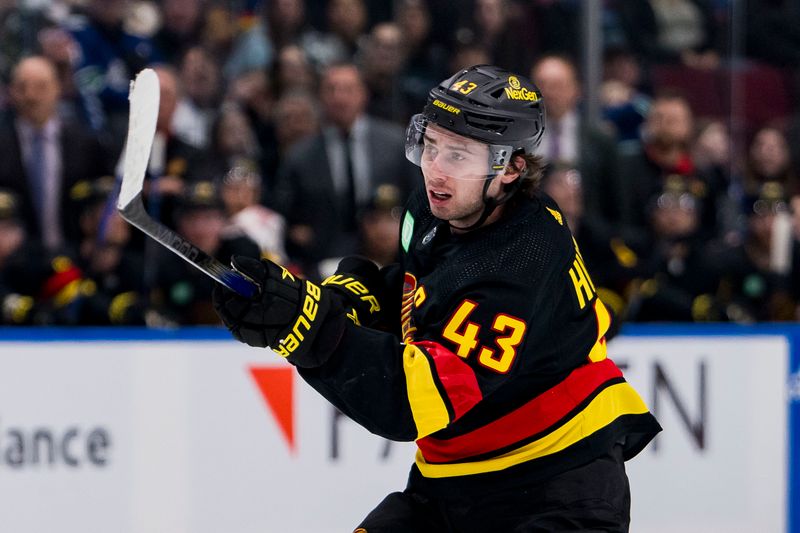 Dec 7, 2023; Vancouver, British Columbia, CAN; Vancouver Canucks defenseman Quinn Hughes (43) shoots against the Minnesota Wild in the first period at Rogers Arena. Mandatory Credit: Bob Frid-USA TODAY Sports